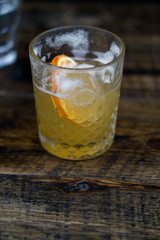 half drank whiskey cocktail on a wooden table