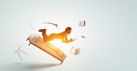 Fototapeta premium Joyful happe businessman levitating horizontally