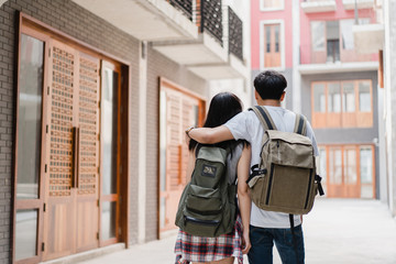 Traveler Asian backpacker couple feeling happy traveling in Beijing, China, cheerful young teenager couple walking at Chinatown. Lifestyle backpack tourist travel holiday in city concept.