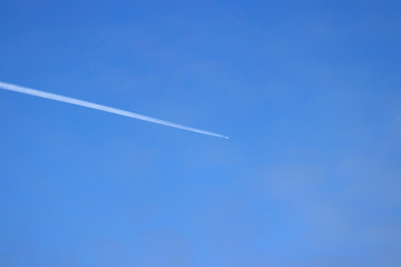 Airliner crossing the Pacific ocean in clean blue sky.