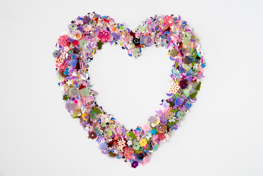 A heart shape made of glittering decoration on a white background. Festive and celebration, Valentine's Day concept. Love symbol.