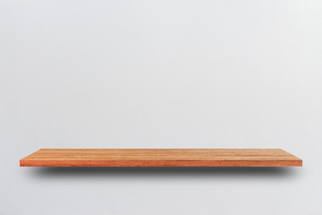 Front view empty wooden shelf and grey wall. Design concept