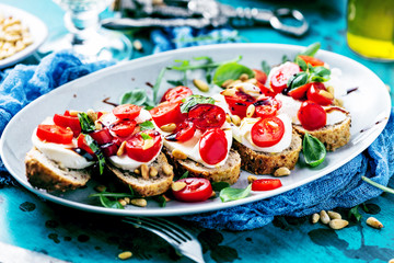 Italienisches Bruschetta mit gehackten Tomaten, Basilikum und Mozzarella auf gegrilltem knusprigem Brot