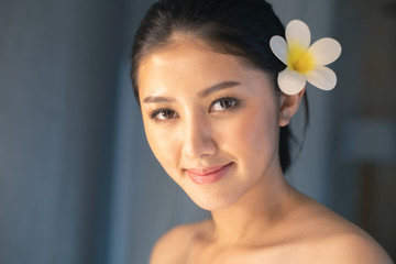 Asian Beautiful, young and healthy woman in spa salon. Massage treatment spa room  . Traditional medicine and healing concept.