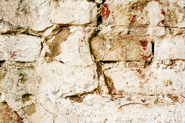 Texture of a brick wall with cracks and scratches which can be used as a background