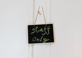 small blackboard hanging on door