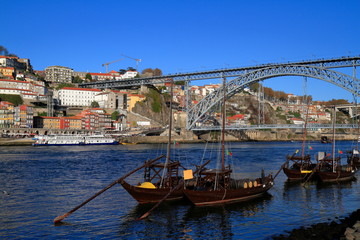 Fototapeta na wymiar Traditional rabelo boats, Porto city skyline, Douro river and and Dom Luis or Luiz iron bridge. Porto