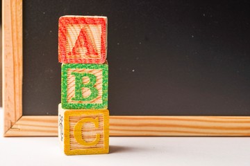 ABC Wooden blocks against chalkboard 