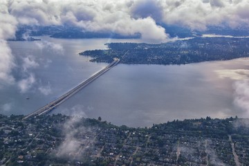 Seattle, Washington, 2019 Cityscape Aerial Panoramic View through cloudscape including Ocean, rivers and rural urban. USA.