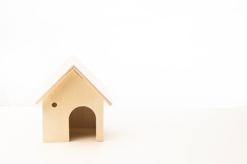 Miniature wooden house isolated against white background 