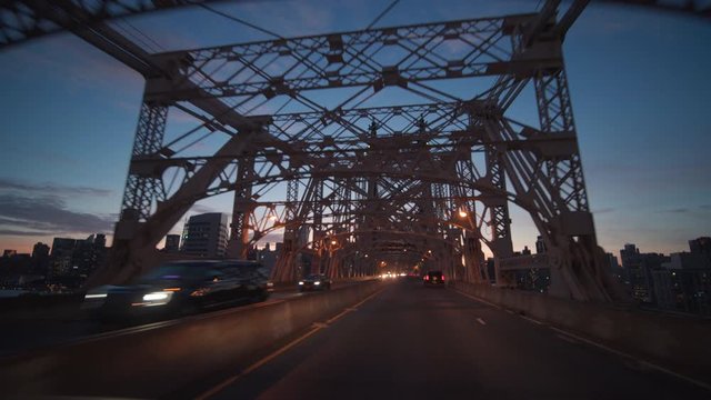 alt evening POV driving mid Queensboro Bridge towards Manhattan