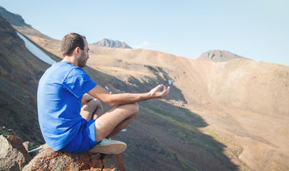 Caucasian man meditating in outdoors.