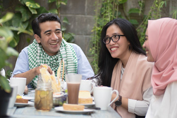 Fototapeta na wymiar group of happy young muslim having dinner outdoor during ramadan celebration