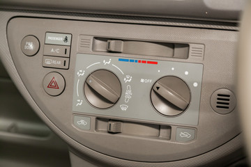 Modern beige car interior: climat control view with air conditioning button, the dashboard with information about temperature inside a car.