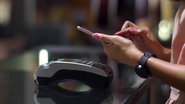 Young woman using smartphone to payment with credit transaction