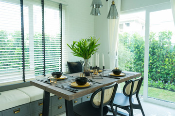 dining table with black and yellow plate setting in modern home.