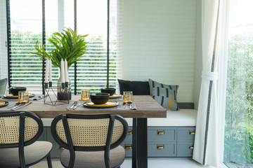 dining table with black and yellow plate setting in modern home.