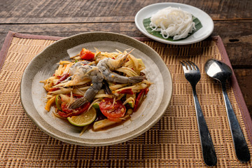 Thai papaya salad (Somtum) on table. Top view, free space for your message.