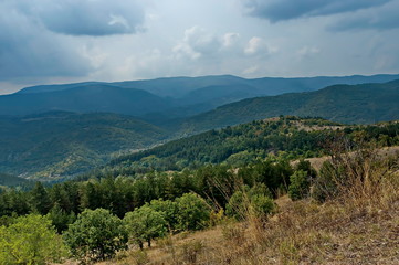 Fototapeta na wymiar Amazing autumn view of glade, peak and forest with deciduous trees in Sredna gora mountain, Bulgaria 
