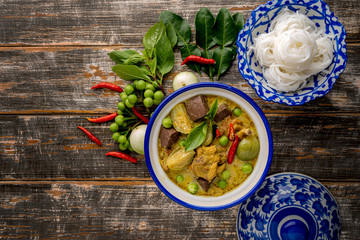 Thai food chicken green curry on dark wooden background. top view , Free space for text input