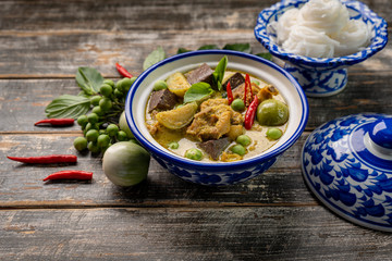 Thai food chicken green curry on dark wooden background. top view , Free space for text input