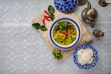 Thai food chicken green curry on dark wooden background. top view , Free space for text input