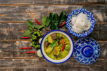 Thai food chicken green curry on dark wooden background. top view , Free space for text input