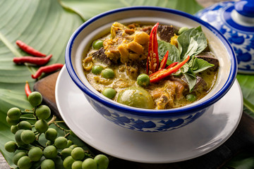 Thai food chicken green curry on dark wooden background. top view , Free space for text input