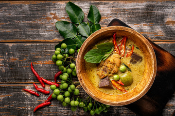 Thai food chicken green curry on dark wooden background. top view , Free space for text input