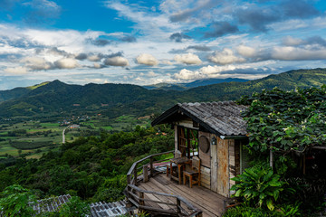 Fototapeta na wymiar Beautiful mountains and skies , Mountain house , Wooden hut in the valley