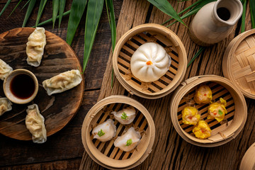Dim sum, Dim Sum on the wooden table, top view and space for text input , Dim Sum (Chinese food) in...