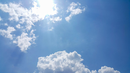 beautiful background of clouds, clearly visible lines of white clouds and blue sky, the top is a sunbeam, copy space for text