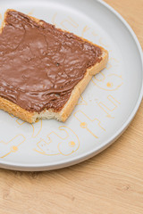 Chocolate nuts cream on a bread slice
