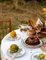 chocolate bundt cake with chocolate glaze on vintage plates on table with grey tablecloth