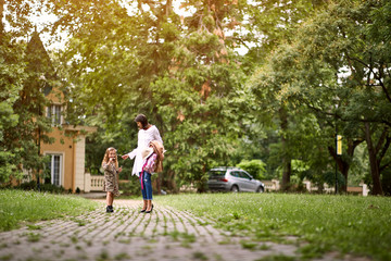 Mother and girl going home from school.
