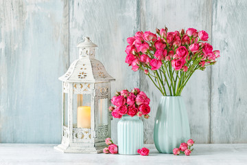 Bouquet of pink roses in blue ceramic vase. Postcard motif.