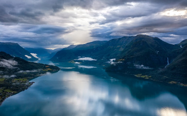 Cloudy morning in Lustrafjord with feigumfossen waterfall, Norway