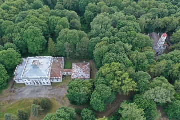 Old historical church and manor palace in derelict park, aerial