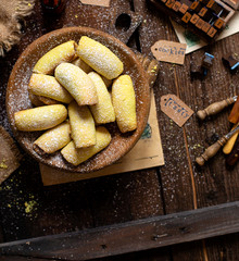 homemade shortbread yellow baked rolled cookies or bagels with apple jam in wooden round plate