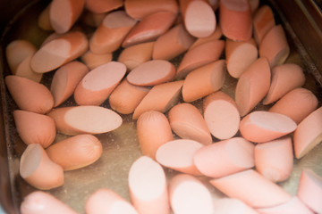 Cooked sliced sausages in a dish close-up.