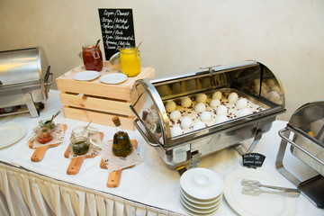 A dish with boiled chicken eggs in on a decorated table in a restaurant.