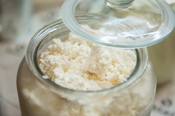 Cottage cheese in a glass jar closeup.