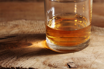 close up scotch whiskey in glass on a wooden table with a blank space for a text, scotch whiskey in rustic bar background