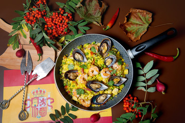 Seafood risotto in a pan on a decorated table top view. Restaurant dishes.