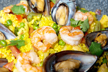 Close-up of seafood risotto in a pan on a decorated table. Restaurant dishes.