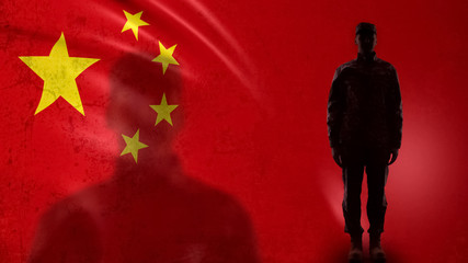 Chinese soldier silhouette standing against national flag, proud army sergeant
