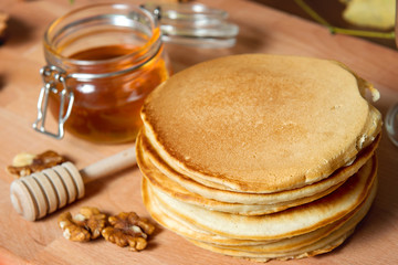 Pancakes with honey on a decorated table. Restaurant dishes.