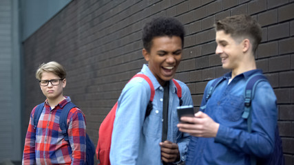 Cruel schoolmates laughing at video about bullied boy, offensive post in network