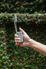 Hand on reusable collapsible drinking straw