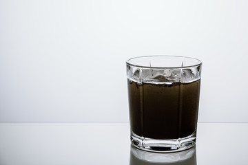 glass on the lumen with poured whiskey with a copy of the space